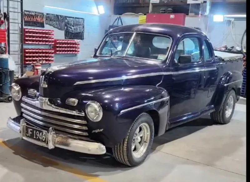 The 1946 Ford ute in deep purple with chrome grille and bumper refitted, inside the Kohl Customs workshop at Kuku