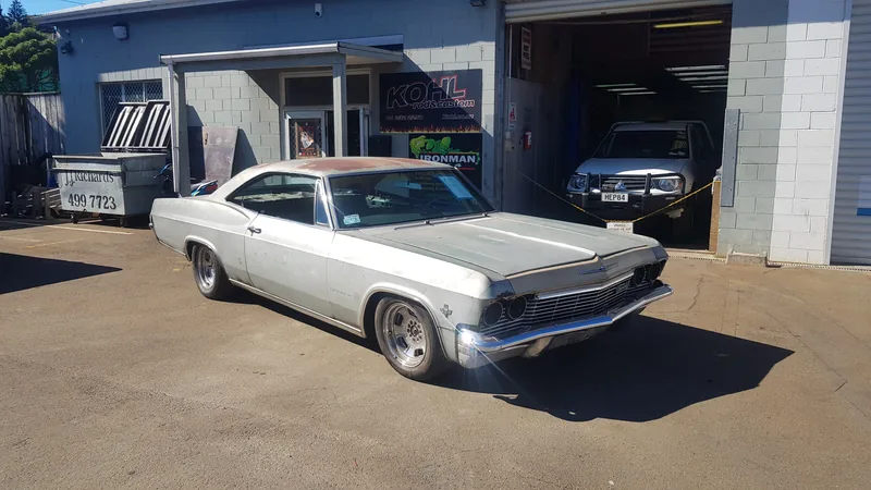 The 1965 Chevrolet Impala in its original white, parked outside the Kohl Customs workshop the day it arrived