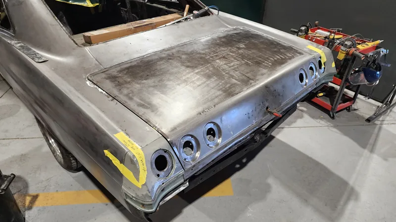 Metalwork on the tail panel and rear quarter of the 1965 Impala at Kohl Customs, tail light openings masked