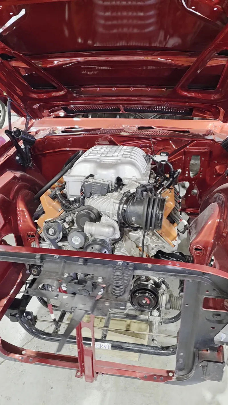 Supercharged 6.2L Hellcat V8 sitting in the engine bay of the 1971 Dodge Challenger at Kohl Customs