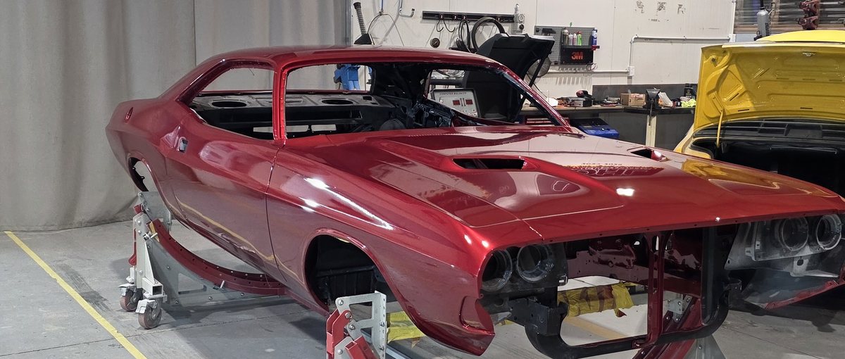 1971 Dodge Challenger in custom metallic red, on stands in final assembly at the Kohl Customs workshop