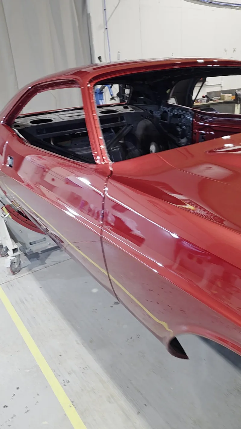 Rear three-quarter of the 1971 Dodge Challenger body in custom metallic red at Kohl Customs
