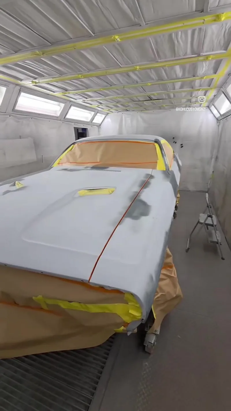 The 1971 Dodge Challenger sealed in grey poly primer and masked up in the Kohl Customs spray booth