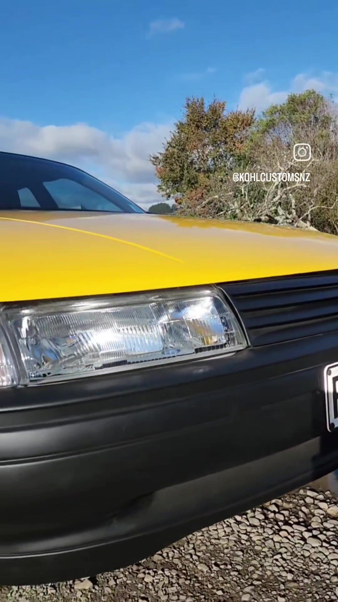 Benny's 1989 VN Holden Commodore finished in HSV Devil Yellow, front three-quarter view outside the Kohl Customs workshop