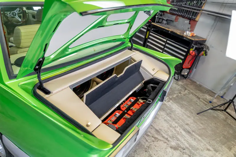 Boot of the VH Commodore showing the trimmed lidded side compartment holding tie-down straps