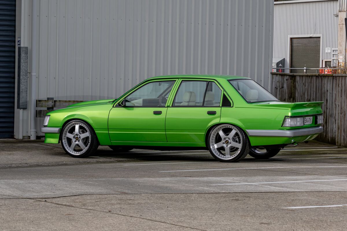 Side profile of the finished candy green 1983 VH Holden Commodore restored by Kohl Customs, sitting on staggered polished rims