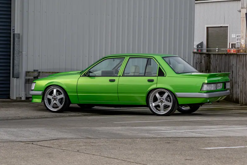 Side profile of the finished candy green 1983 VH Holden Commodore restored by Kohl Customs, on staggered polished rims