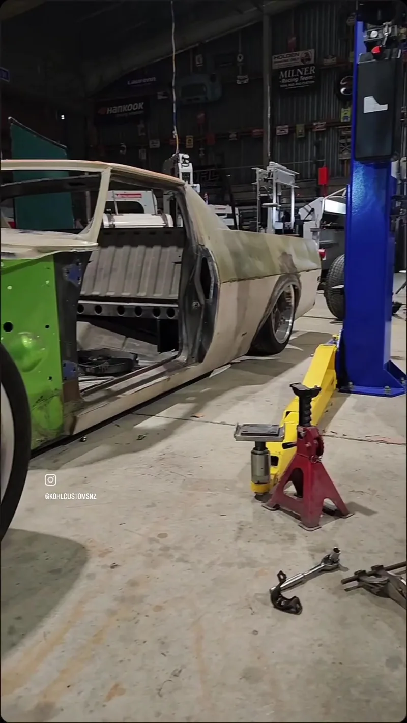 The chopped HJ Holden ute body mocked up on stands, showing the original green paint on the rear quarter