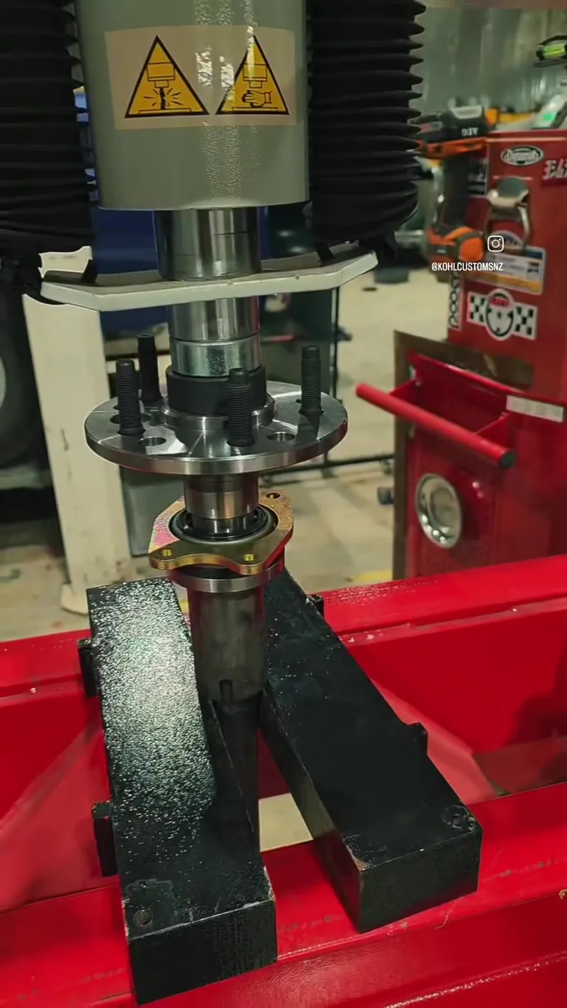 Pressing a bearing into the fabricated rear axle housing on the workshop press at Kohl Customs
