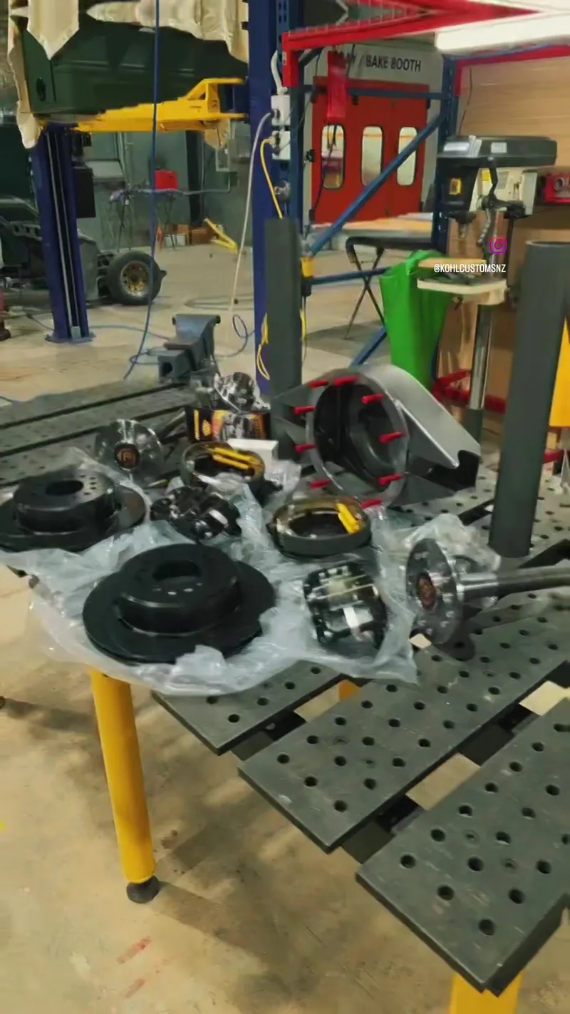 Rear axle housing components laid out on the fabrication jig table at Kohl Customs