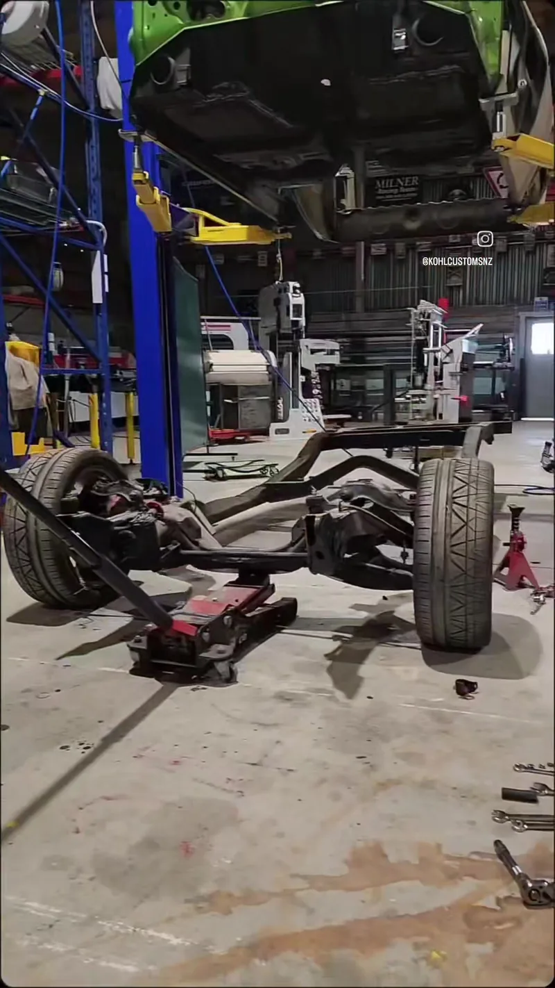 Underside of the HJ Holden ute up on the two-post hoist at the Kohl Customs workshop